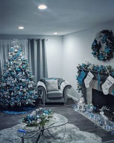 a living room decorated for christmas with blue and silver decorations