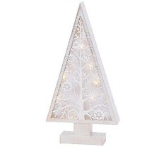 a small white christmas tree with lights on it's sides and an ornament in the shape of a snowflake