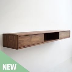 a wooden shelf mounted to the side of a wall