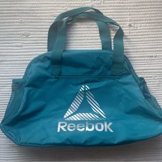 28l 13.5” X 21” X 5” Condition: New Without Tags Water Resistant Compact Size Valuable Pockets Side Pockets For Bottles Merry Tote N Seaport Green Activity: Gym Fitness Workout Reebok Gym Bag, Green Activities, Teal Green Color, Activity Gym, Reebok Women, Womens Reebok, Sporty Outfits, Gym Fitness, Fitness Workout