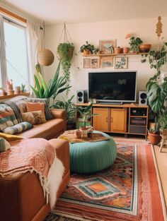 a living room filled with lots of plants next to a flat screen tv mounted on a wall