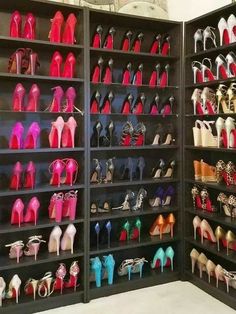 a large display case filled with lots of different colored high heeled shoes on shelves