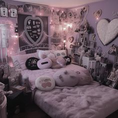 a bedroom decorated in pink and white with lots of decorations on the wall above the bed