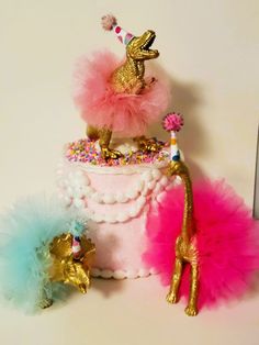 there is a cake decorated with gold and pink decorations