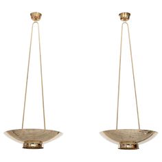 two brass hanging bowls with metal handles on each side, one is empty and the other has