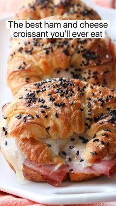 ham and swiss croissants on a white plate with poppy seed sprinkles