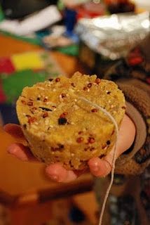 a person holding a cookie in their hand with some string attached to the top of it