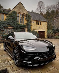 a black car parked in front of a house