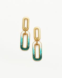 Enamel Haze Ombre Ovate Drop Hoop Earrings 18ct Gold Plated/White & Teal. These Statement Drop Link Hoops Feature Ultra-Unique Ombré Enamel Detailing, a Spectrum of Luminescent White, Aqua, and Teal. Let Them Dangle Solo or Style with Mini Hoops and Studs for an Instant Ear Stack. Metal: 18Ct Recycled Gold Plating on Brass Materials: White, Aqua and Teal Enamel Gradient Dimensions: 46. 40mm X 13. 50mm Weight: 11. 4g All the Enamel is Hand Painted and Because of Its Luminescent Finish, the Colour Drop Hoop Earrings, Ear Stack, Recycled Gold, Recycled Sterling Silver, Brass Material, Conflict Free Diamonds, White Metal, Unique Earrings, Jewelry Care