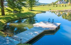 there is a dock on the water in the yard