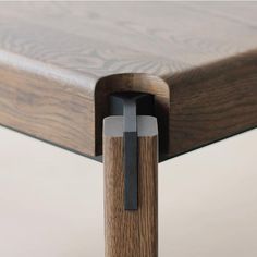 a close up of a wooden table with a metal cross on the top and bottom