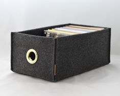 a black box with cd's in it on a white surface