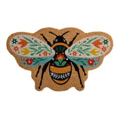 a door mat with a bee on it's back and flowers in the middle