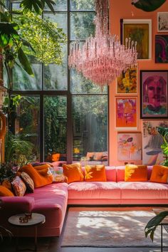 a living room filled with furniture and lots of windows covered in pink curtains, chandelier