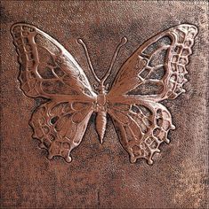 a metal plate with a butterfly on it