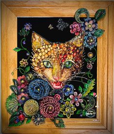 a painting of a cat with flowers and butterflies on it's face in a wooden frame