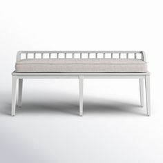 a white bench sitting on top of a white floor