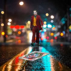 a toy joker walking down the street at night