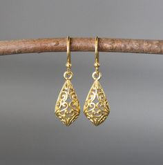 "24k matte gold vermeil filigree charms dangle from 18k gold vermeil balled earwires. Wear these elegant earrings everyday as they complete any outfit. Gold filigree charms: 9x19mm Total length of earrings: 1 1/8\" All gold is gold vermeil. This earrings are available in bright silver... www.etsy.com/listing/630528036/silver-filigree-earrings These earrings are also available in oxidized silver... www.etsy.com/listing/688867970/silver-filigree-earrings As the owner, maker, designer, and curator Luxury Gold Danglers With Elegant Design, Luxury Elegant Gold-plated Danglers, Luxury Gold Danglers In Sterling Silver, Luxury Gold-plated Gold Danglers, Luxury Traditional Yellow Gold Danglers, Gold Teardrop Earrings With Intricate Design, Gold Teardrop Earrings With Intricate Design As Gift, Gold Teardrop Earrings With Lever Back As Gift, Gold Teardrop Earrings As Gift