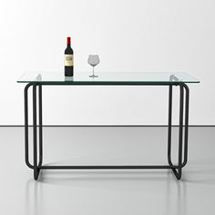 a glass table with a bottle of wine on it