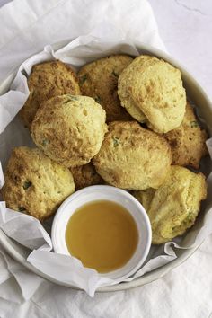 a bowl filled with fried food next to dipping sauce