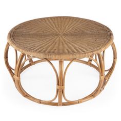 a wicker coffee table with circular design on the top and bottom, sitting against a white background