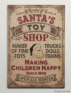 a sign advertising santa's toy shop on the wall