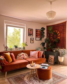 a living room filled with furniture and lots of plants