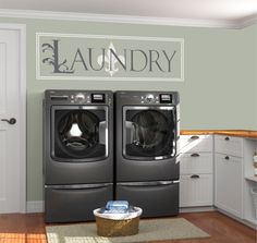 a laundry room with two washers and dryer