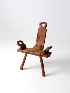 an old wooden chair sitting on top of a white floor