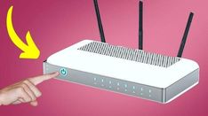 a hand pointing at a router with two antennas attached to the back of it