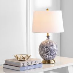 a table with a lamp and books on it