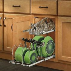 an open dish rack with green dishes in it