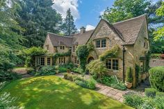 a large house surrounded by lush green trees