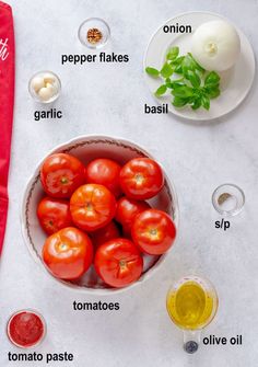 tomatoes in a bowl with ingredients to make them