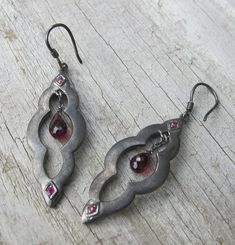 "A unique bohemian pair of Moroccan-inspired dangle earrings handcrafted in oxidized sterling silver accented with a garnet and ruby. A stunning and one-of-a-kind earring that make a great birthstone earrings for the month of January(Garnet) and Ruby(July) (E.96) *Follow us @belesasjewelry on Instagram for promotions/giveaways *LIKE* us on Facebook http://www.facebook.com/Belesas *If you like the ring, please click on the \"Pin It\" icon ---------------------------------------------------- ENTER Antique Silver Jewelry Vintage, Black Earrings Dangle, Earrings Stone, Earrings Gemstone, Birthstone Earrings, Nail Jewelry, Dope Jewelry, Statement Earring, Garnet Earrings