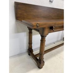 a wooden table with two drawers on it