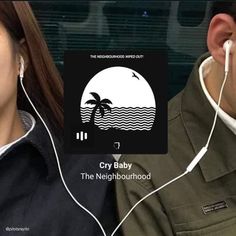 two people wearing ear buds and headphones, one is listening to the other's ear