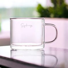 a glass mug sitting on top of a table