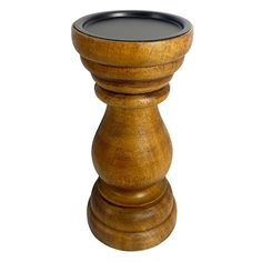 a wooden candle holder with a black glass top on it's stand, isolated against a white background