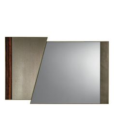 a mirror that is sitting on top of a wall next to a piece of wood