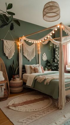 a bedroom decorated in shades of green and white, with lights strung from the ceiling