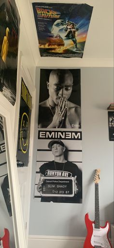 a room with posters and guitars on the wall