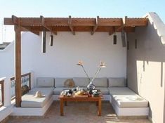 an outdoor living area with couches and tables