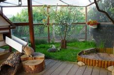 a wooden deck with benches and trees in the background