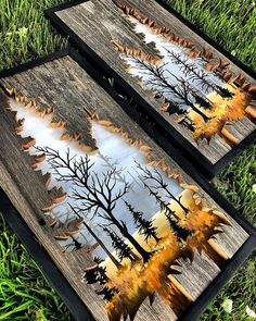 two wooden boards with trees painted on them