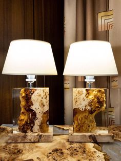 two lamps sitting on top of a table next to each other in front of a mirror