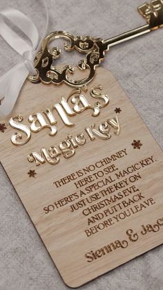 a wooden key tag with the words santa's magic key on it