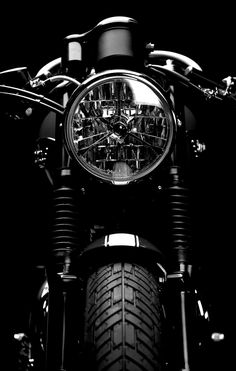 the front end of a motorcycle with its headlights on