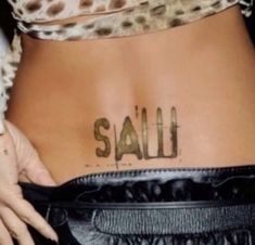 a woman's lower back with the word salli written on her stomach and hand